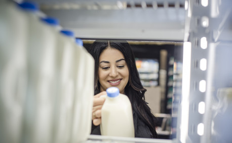 Woman buying milk at grocery