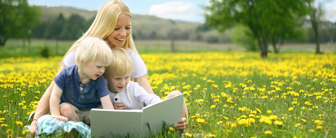 Mother Reading to Children on Farm