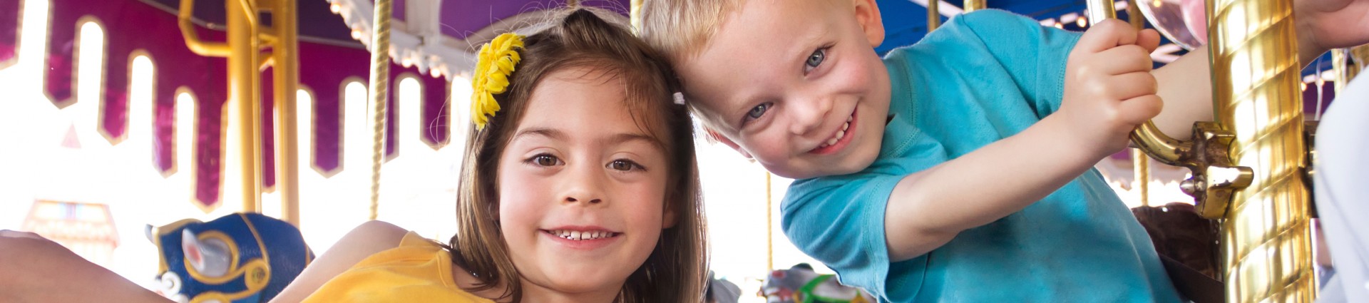 A young boy and girl on a Carousel